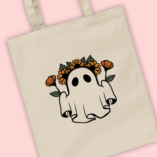 A natural tote bag with an illustration of an autumn ghost wearing a flower crown