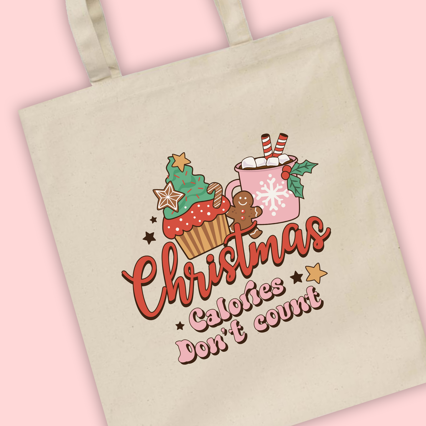 A natural tote bag with ‘Christmas calories don’t count’ written with an illustration of a festive hot chocolate and gingerbread man