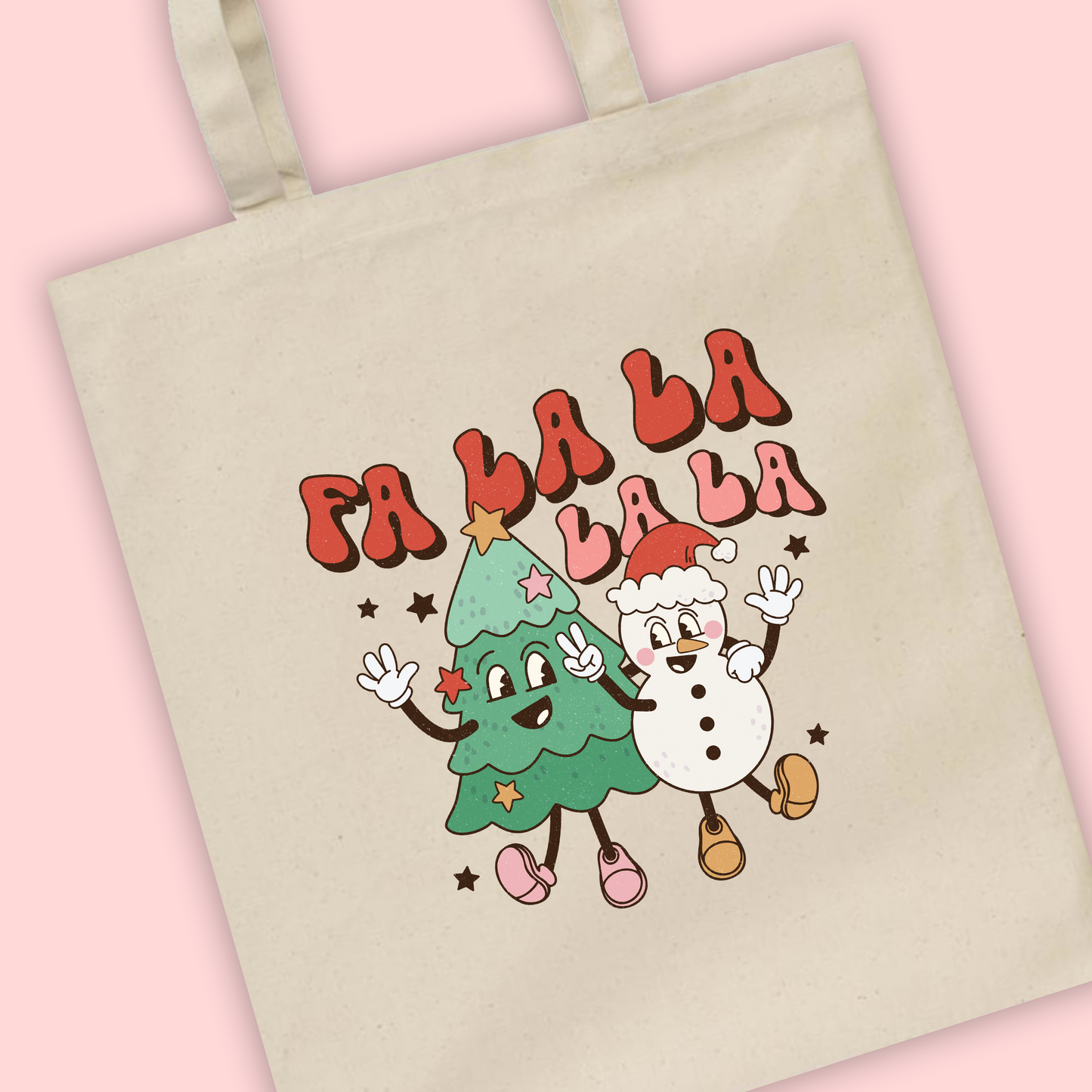 A natural tote bag with ‘Fa La La La La’ written and an illustration of a groovy Christmas tree and snowman with smiley faces