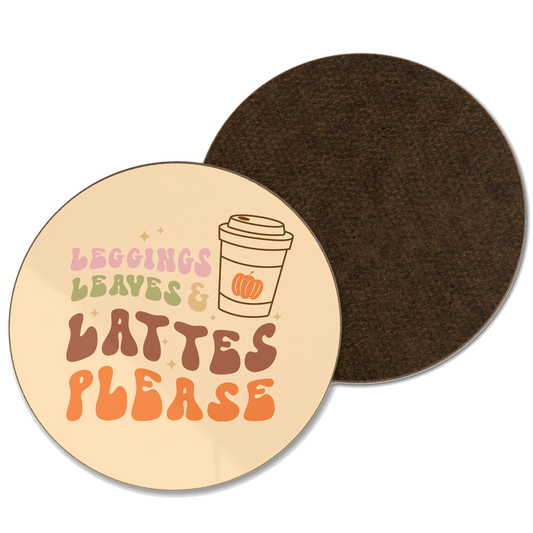 A orange coaster with leggings, leaves and lattes please written with an Illustration of a coffee cup