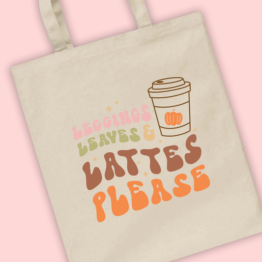 A natural tote bag with ‘leggings, leaves & lattes please’ written with a coffee cup illustration