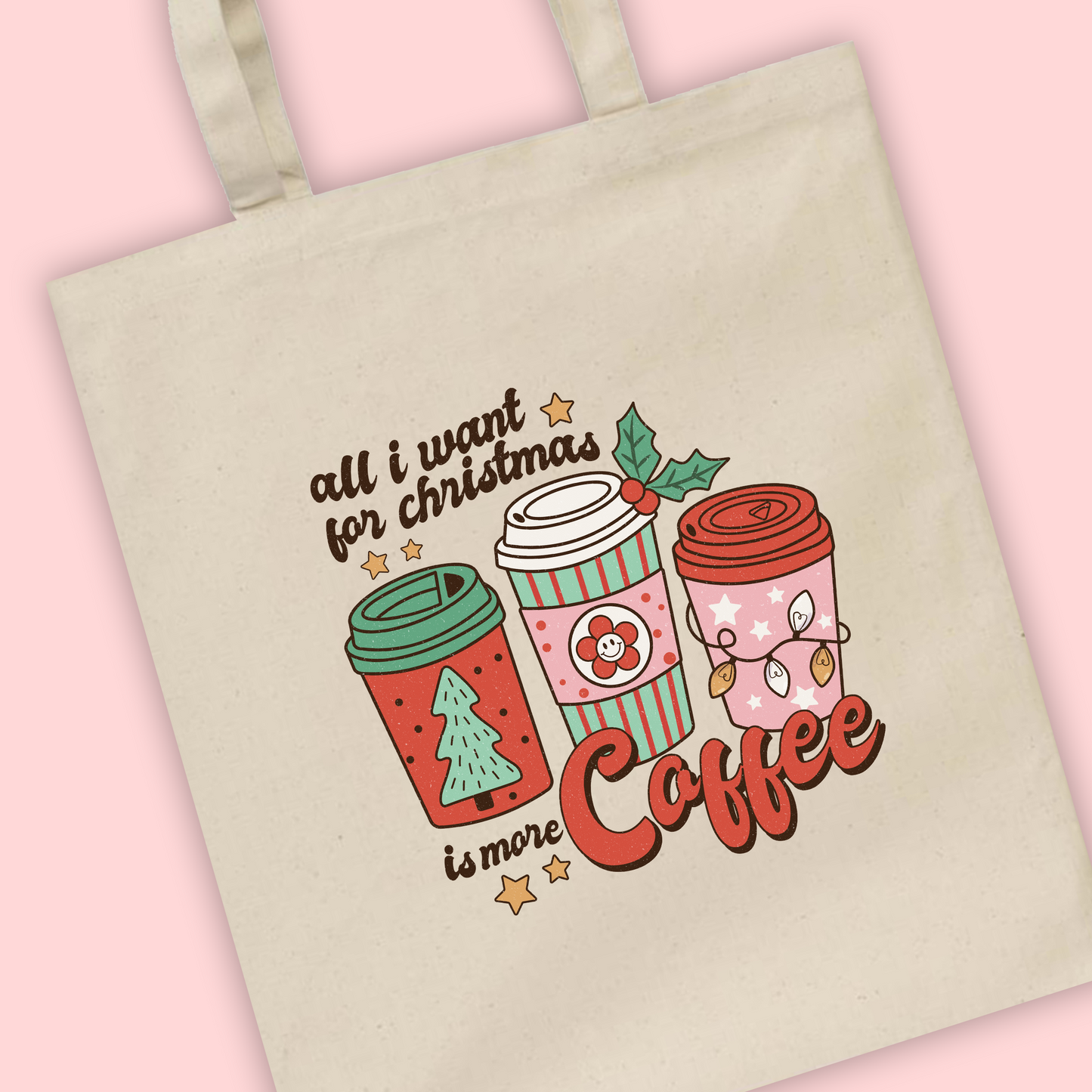 A natural tote bag with ‘All I want for Christmas is more coffee’ written with coffee cup Illustrations