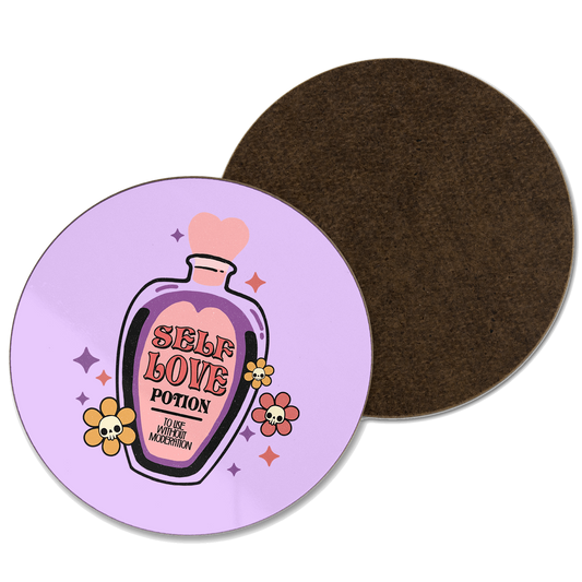 A purple coaster with an illustration of a potion bottle with ‘self love potion’ written