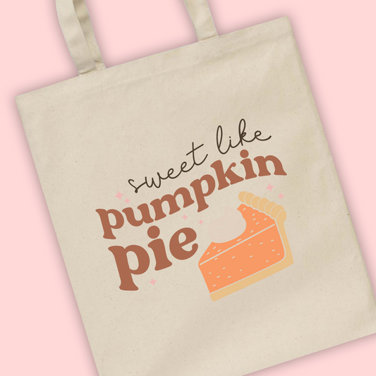 A natural tote bag with Sweet Like Pumpkin Pie written and an illustration of a pumpkin pie