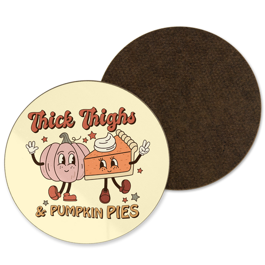 A yellow coaster with ‘Thick thighs and pumpkin pies’ written with a pumpkin pie illustration