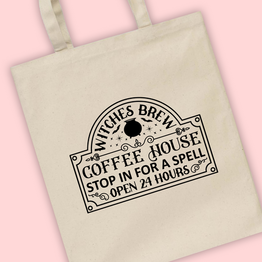 A natural tote bag with a Witches Brew logo illustration on